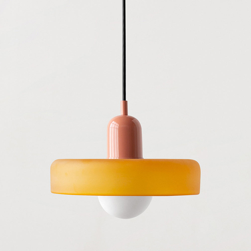 Close view of an amber glass shade with a dusty pink cap and black cord 22