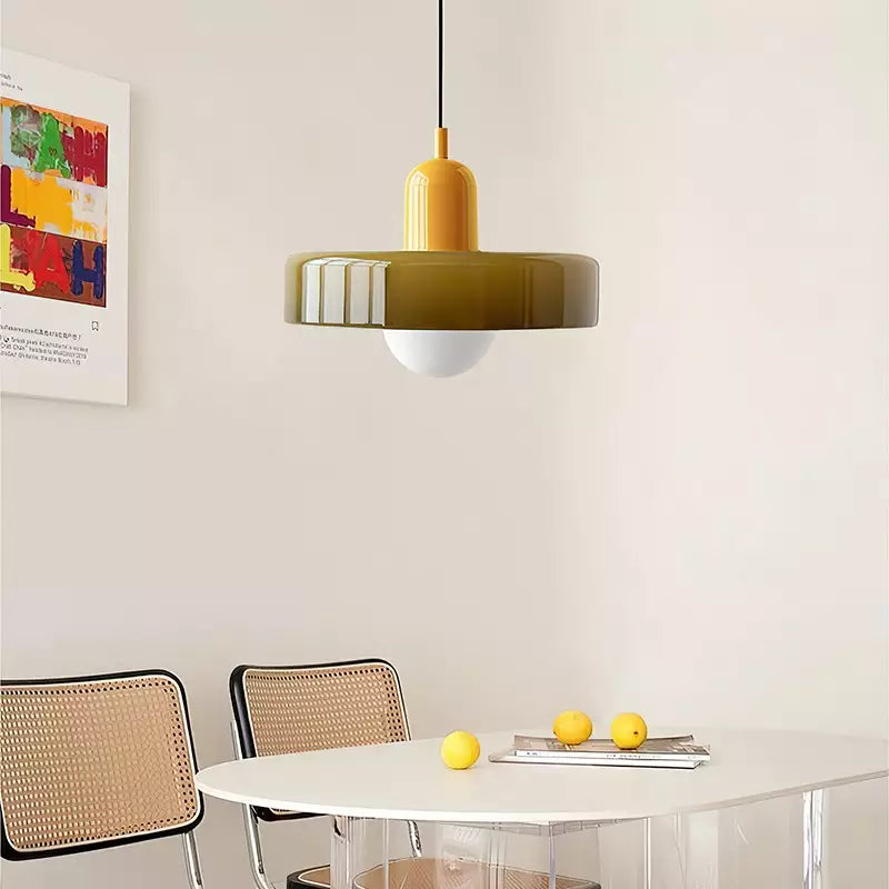 Olive pendant with a yellow cap hangs above a white dining table with lemons 17
