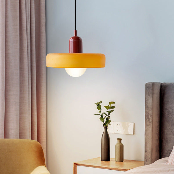 Amber glass pendant with a red cap hanging beside a bed, with curtains and a bedside table with vases 21