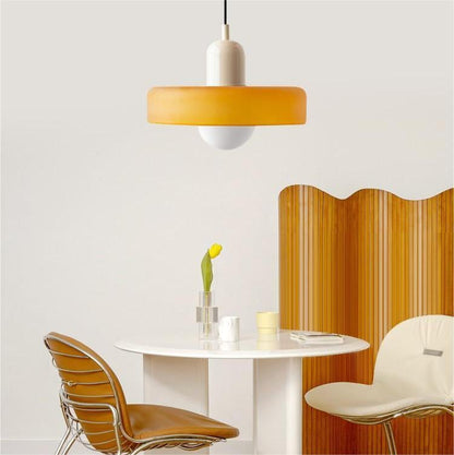 Amber glass pendant with cream cap above a small round table, curved timber screen and two chairs 29