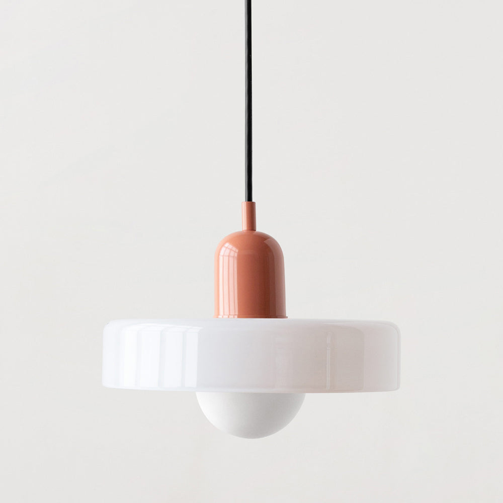 Close view of a white glass pendant with a pink cap, black cord and white globe bulb 40