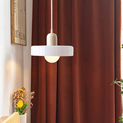 White pendant with cream cap lit in a room beside rust-coloured curtains and dried flowers 47
