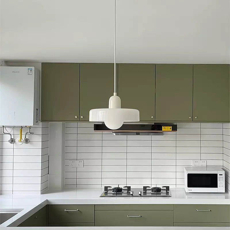 White pendant with cream cap hanging in a kitchen with olive green cabinets and white tiles 47