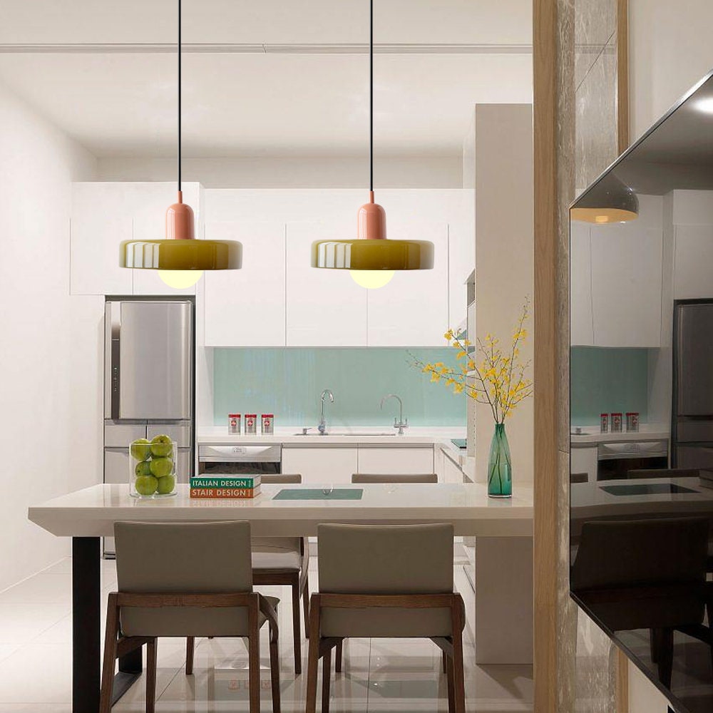 Two olive pendants with pink caps hang above a white kitchen table with green apples 5