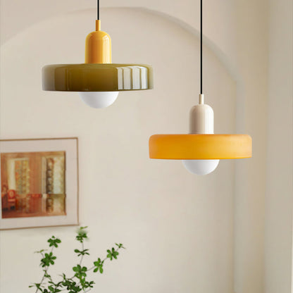 Olive pendant with a yellow cap beside an amber pendant with a cream cap 15