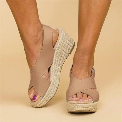 Front and side view of tan crossover-strap wedges on a model, showing the open toe 3