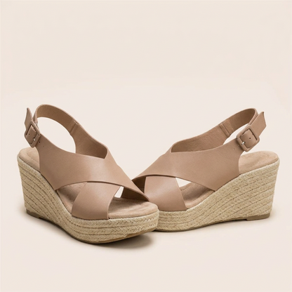 Pair of tan wedges on a plain background, showing buckled heel straps and cushioned footbed 13
