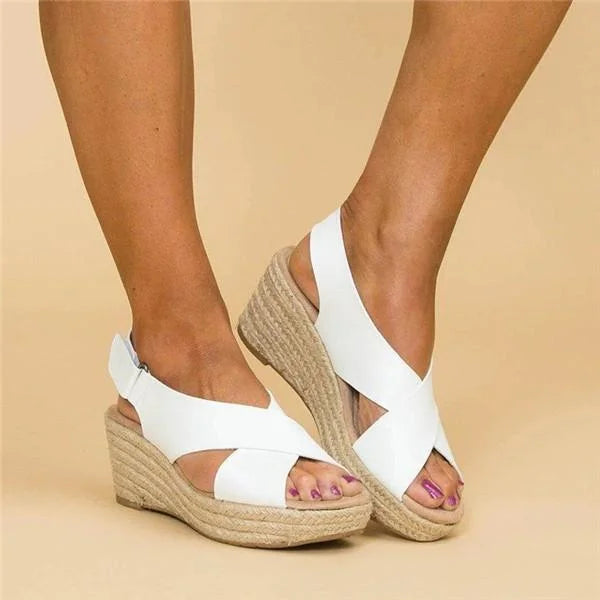 White crossover wedge sandals with peep toe and braided jute sole, seen from the side with heel strap 6