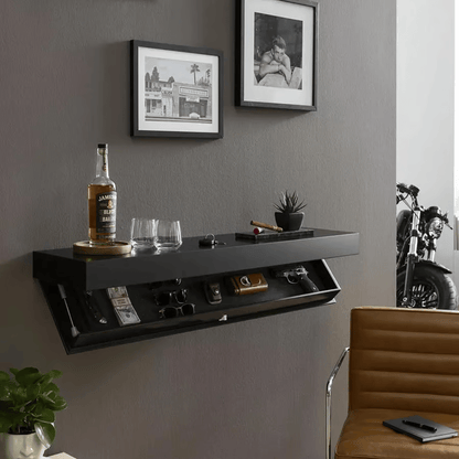 Black floating shelf on a grey living room wall above a leather chair, hidden compartment open and drinks displayed on top. 5