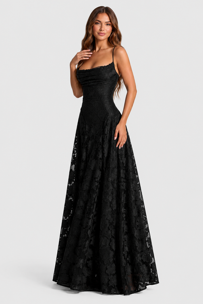 Model in a black lace gown posed three-quarters, one hand at her collarbone, showing the draped neckline and flared skirt. 11