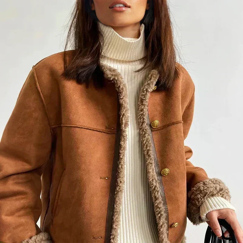 Close-up of the jacket front on a model, showing fleece-lined edges, gold buttons and turned-back cuffs 2