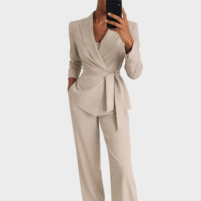 Same wrap-front blazer and wide-leg trousers in a beige colourway, worn by a model taking a mirror selfie. 2