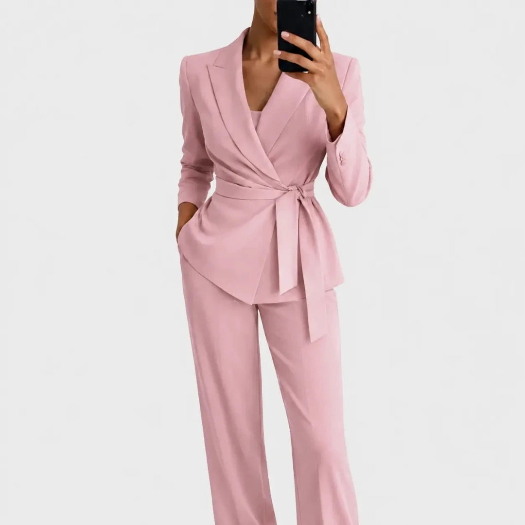 Pink colourway of the wrap blazer with tie belt and matching trousers, shown on a model in a mirror selfie. 4