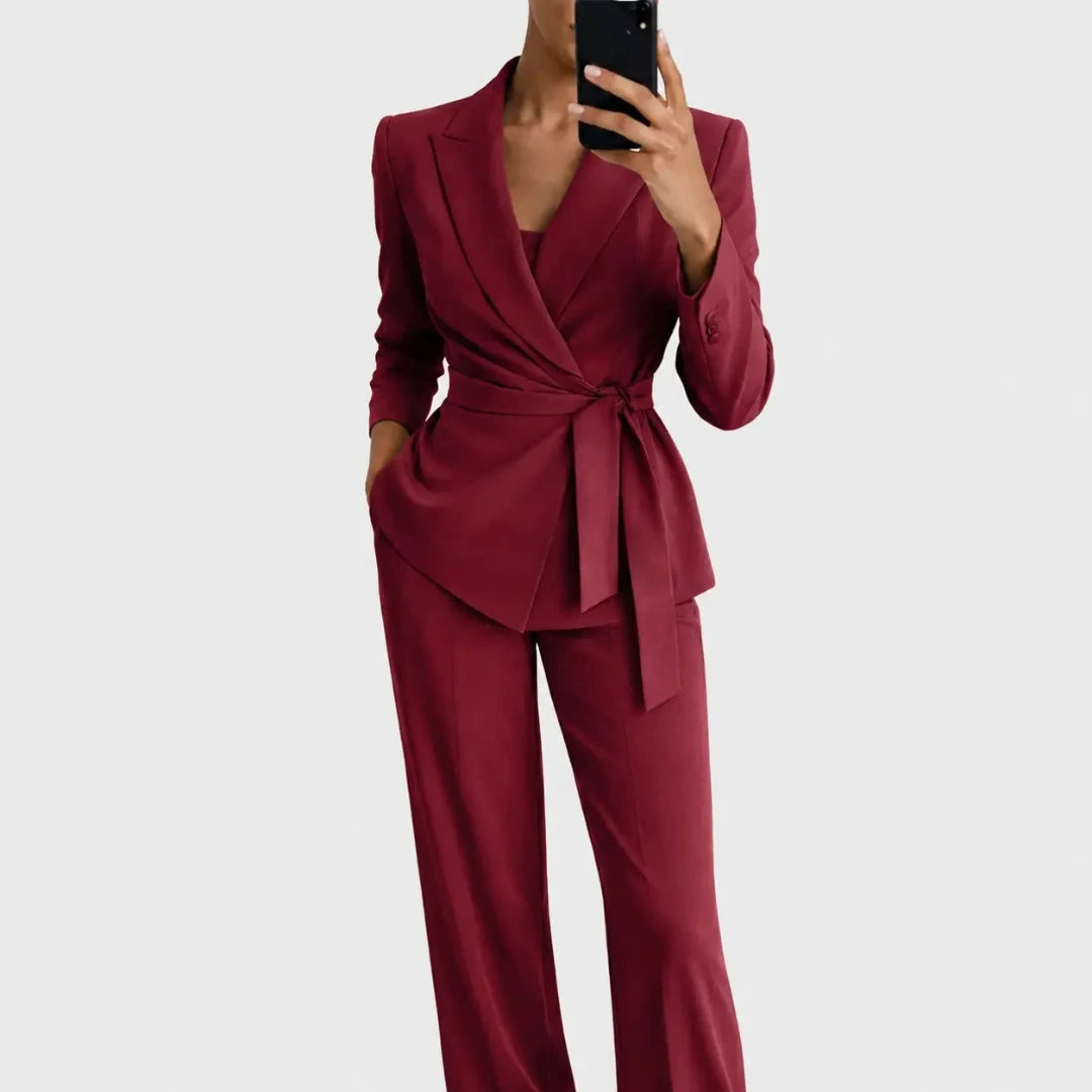 Burgundy red version of the belted wrap blazer and wide-leg trousers, worn by a model holding a phone. 5