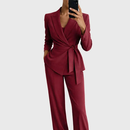 Burgundy red version of the belted wrap blazer and wide-leg trousers, worn by a model holding a phone. 5