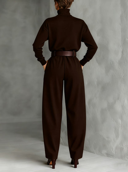 Back view of the dark brown set, with belted trousers and ankle boots on a light floor 6