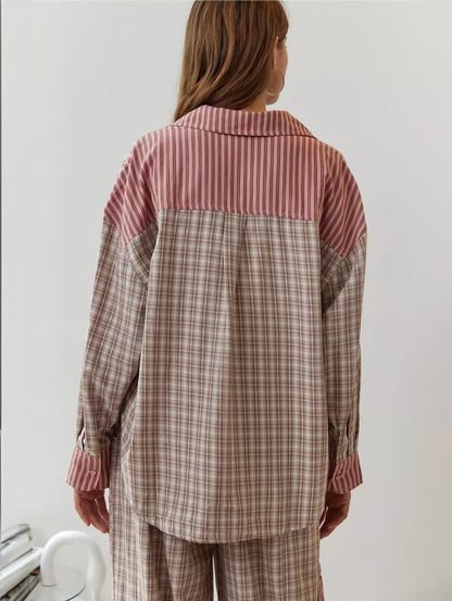 Back view of the pink pyjama shirt, with a pink striped yoke and collar above a beige and pink check body. 8