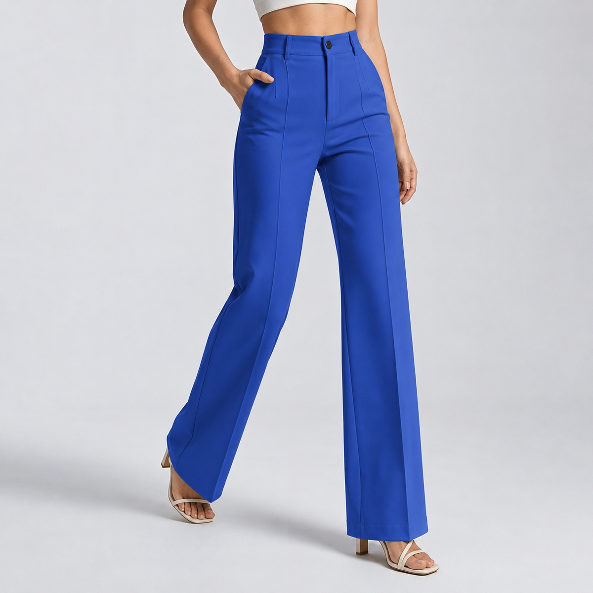 Bright cobalt blue high-waisted trousers on a model, walking pose, hand in the pocket 15