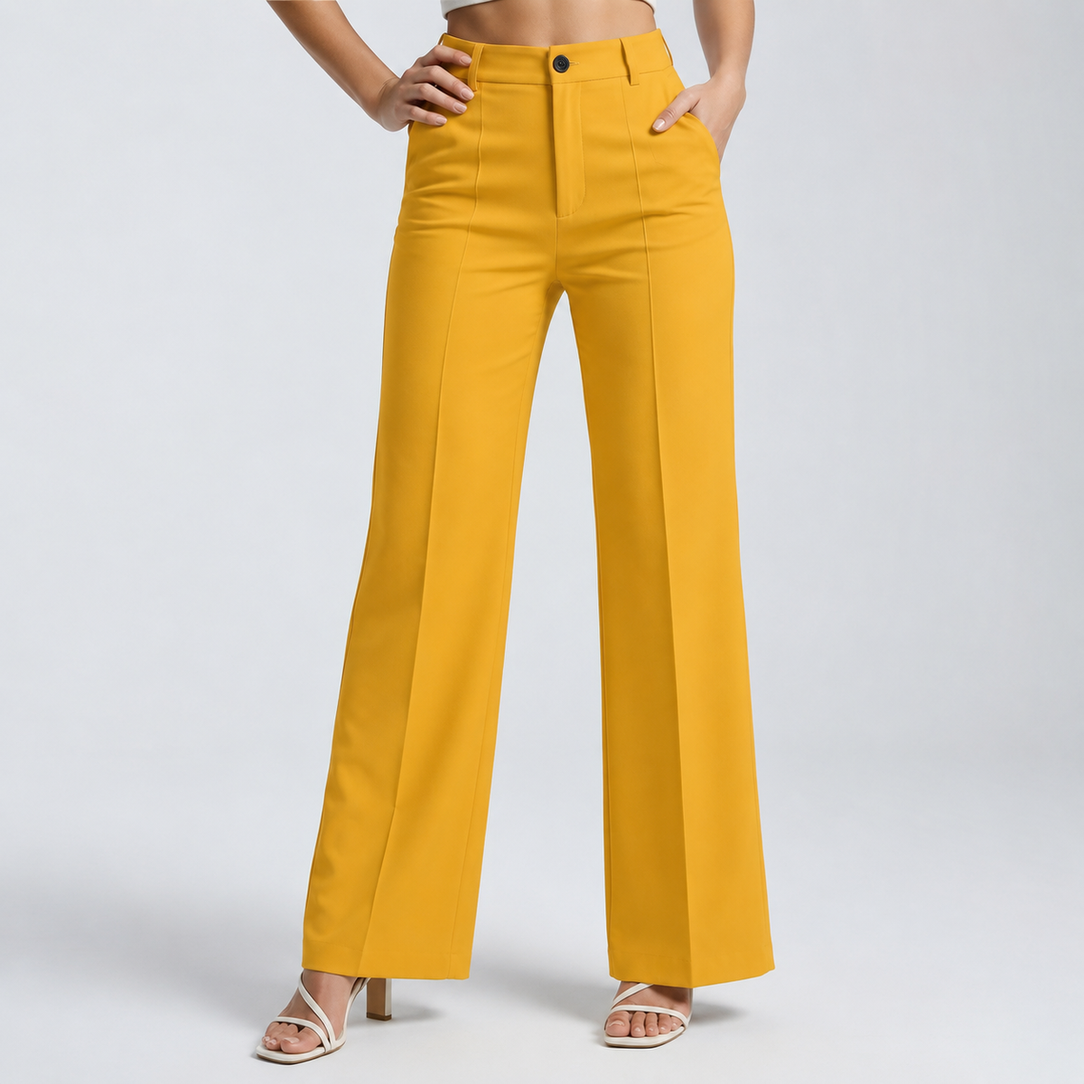 Mustard yellow high-waisted straight trousers on a model with hands on hip and in pocket 17