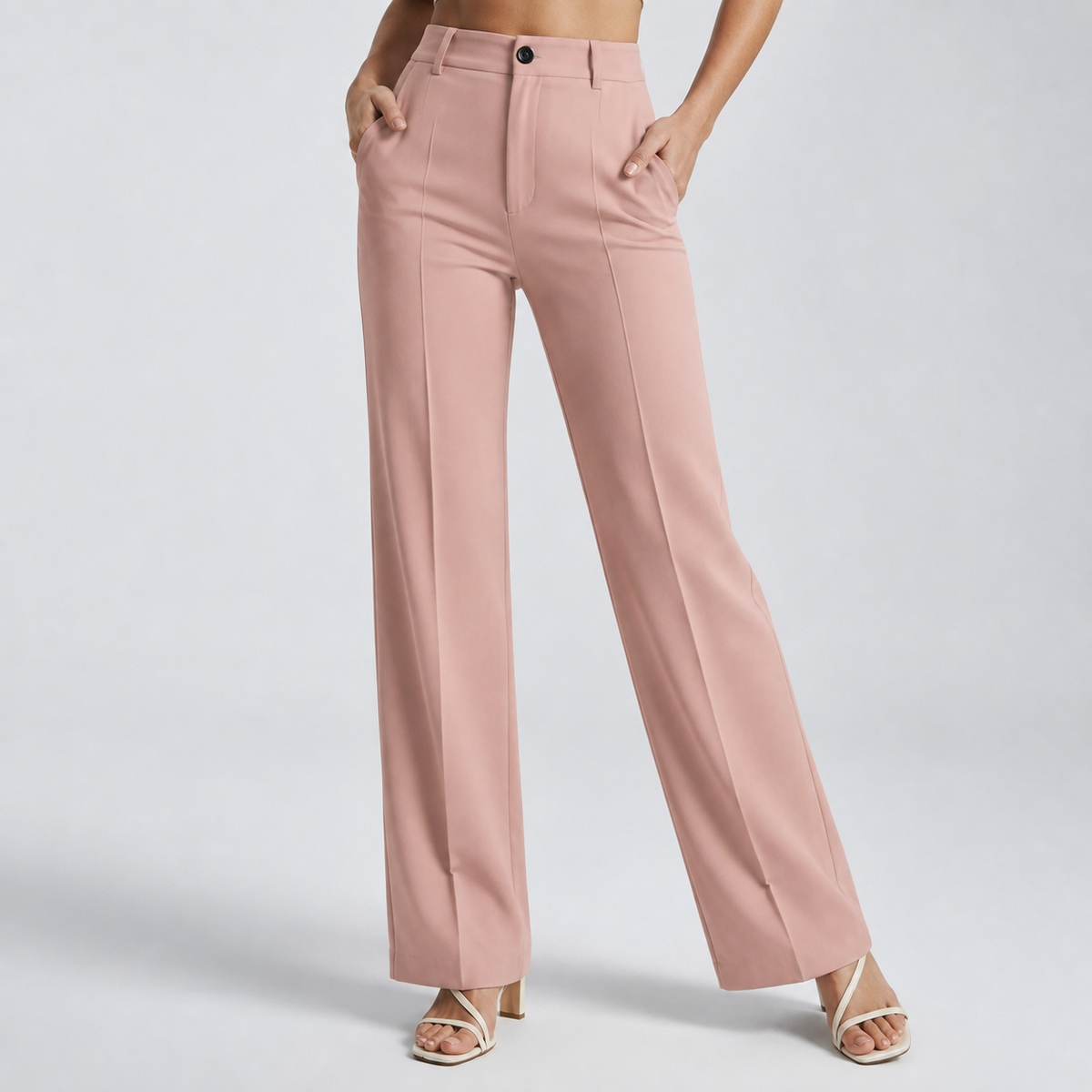 Dusty pink high-waisted trousers with front creases, worn with both hands in the pockets 18
