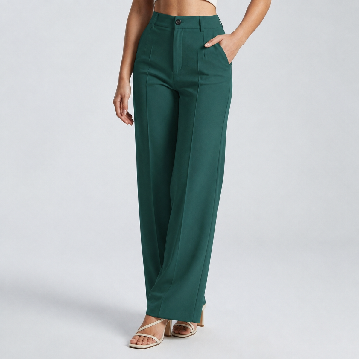 Dark green high-waisted wide-leg trousers on a model, one hand in the side pocket 19