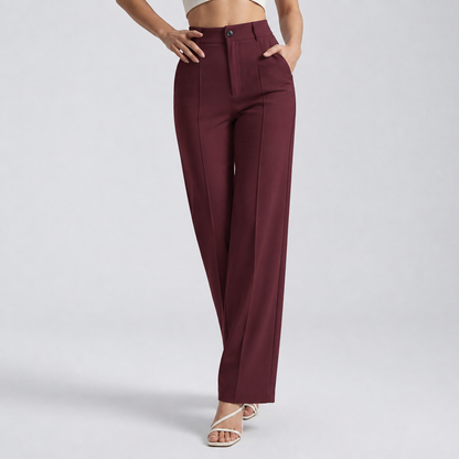 Burgundy high-waisted straight trousers on a model with hands at the hip and in the pocket 9