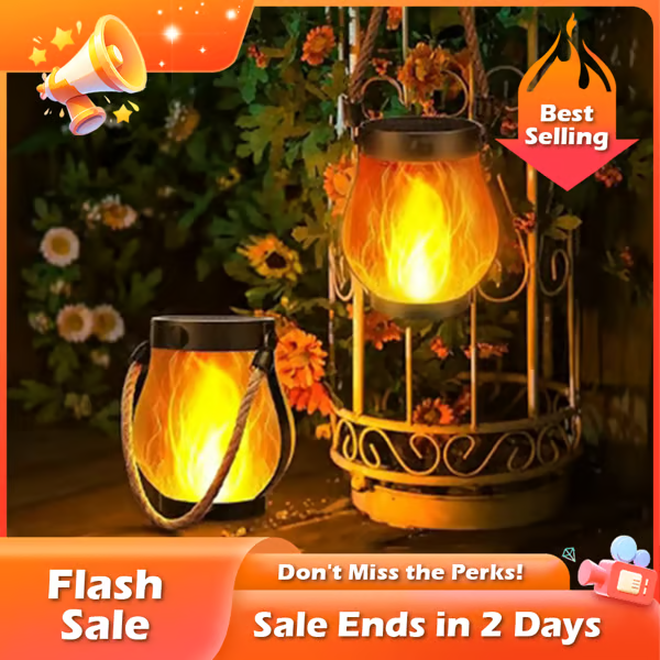 Two flame-effect lanterns glowing among garden flowers, one on the ground and one hanging 2