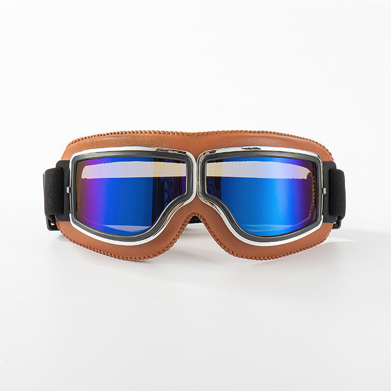 Front view of the tan-padded goggles with chrome trim and reflective blue mirrored lenses on a white background. 9