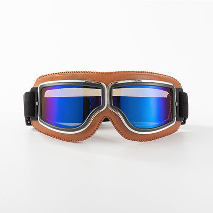 Front view of the tan-padded goggles with chrome trim and reflective blue mirrored lenses on a white background. 9