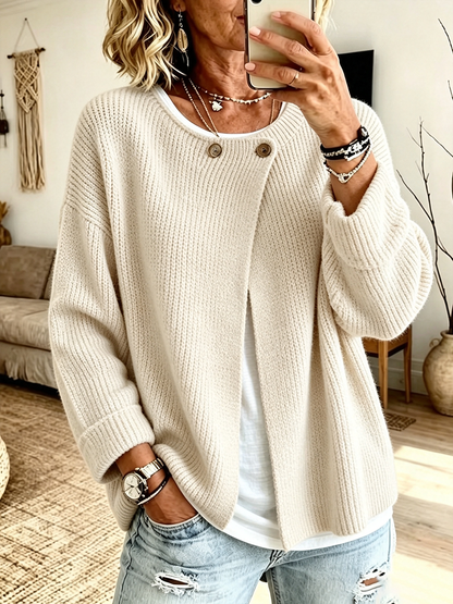 Front view of the cardigan in cream on a model taking a mirror selfie, worn open over a white top 6