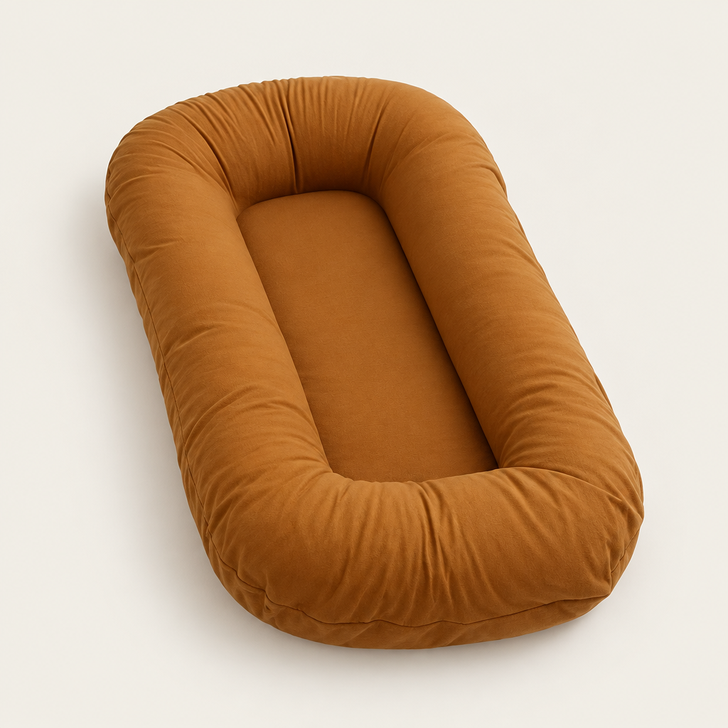 Empty caramel-coloured pillow with raised rounded sides around a flat centre, shown at an angle 9