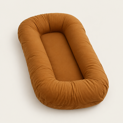 Empty caramel-coloured pillow with raised rounded sides around a flat centre, shown at an angle 9