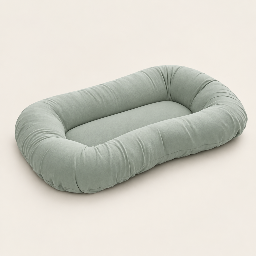 Empty sage green pillow with raised sides and a flat centre, shown at an angle 8