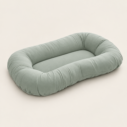Empty sage green pillow with raised sides and a flat centre, shown at an angle 8