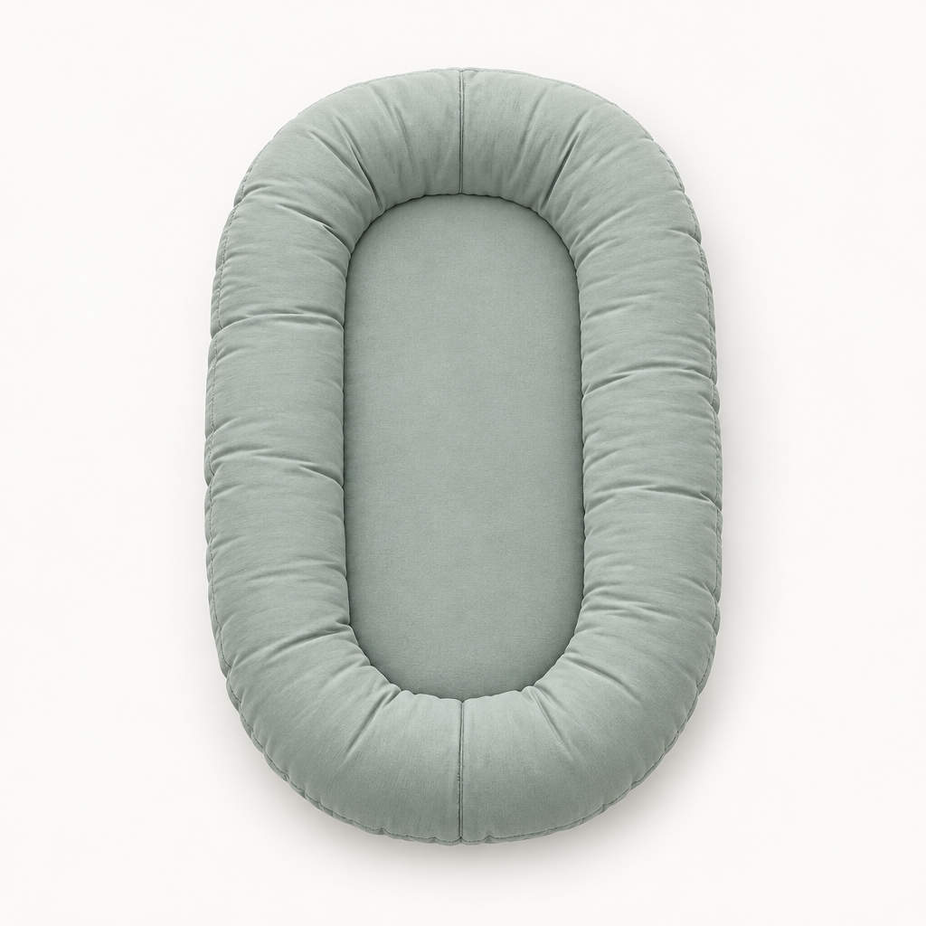 Empty sage green oval lounger seen from above, showing its padded rim and flat centre 8