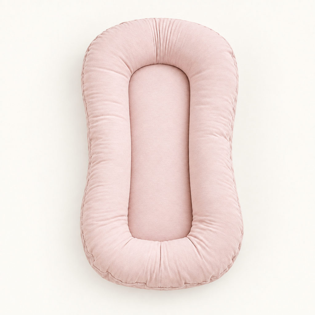 Empty dusty pink lounger seen from above, showing its padded rim and flat centre 10