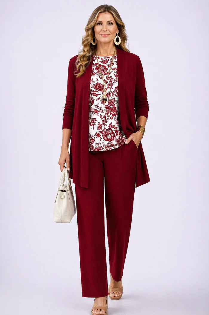 Model wearing a plain red open cardigan and trousers with a white top printed in a red floral pattern. 13