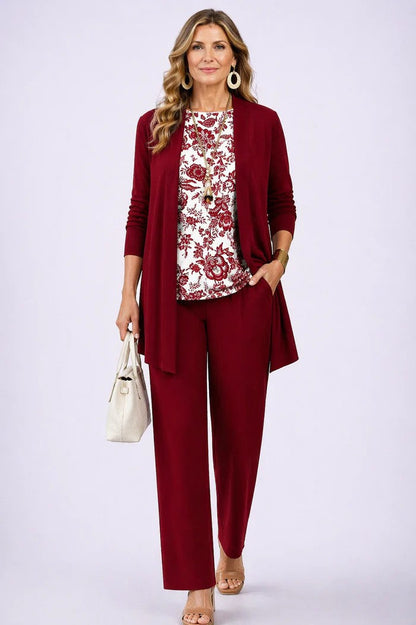 Model wearing a plain red open cardigan and trousers with a white top printed in a red floral pattern. 13