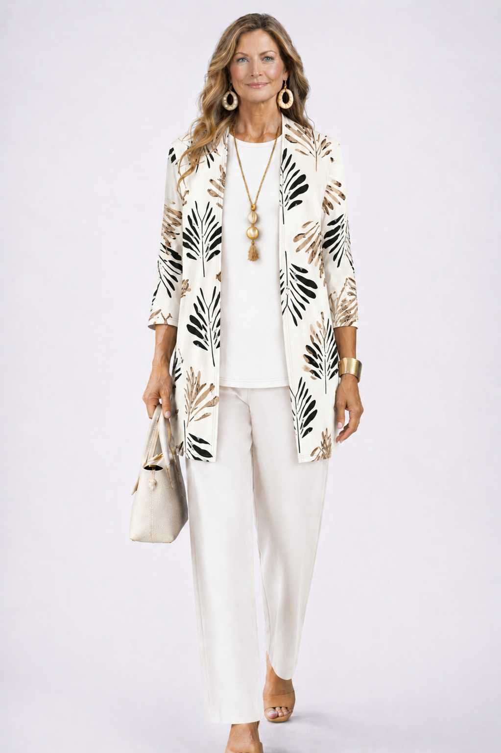 Model in the white set, the open cardigan printed with black and tan palm leaves over a plain top and trousers. 4