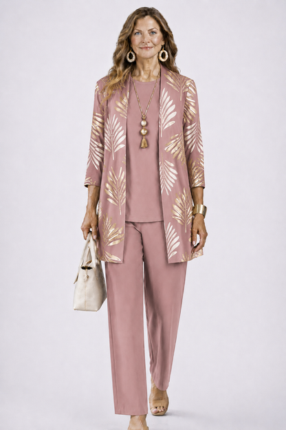 Model in the dusky pink set, the open cardigan printed with gold palm leaves over a matching plain top and trousers. 8
