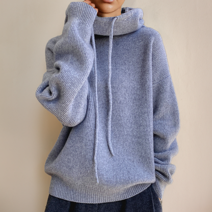 Soft blue-grey knit jumper with long drawstrings and a relaxed fit, worn with dark trousers 6