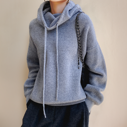 Grey knit jumper with drawstring roll neck, worn with dark trousers and a chain-strap bag 4