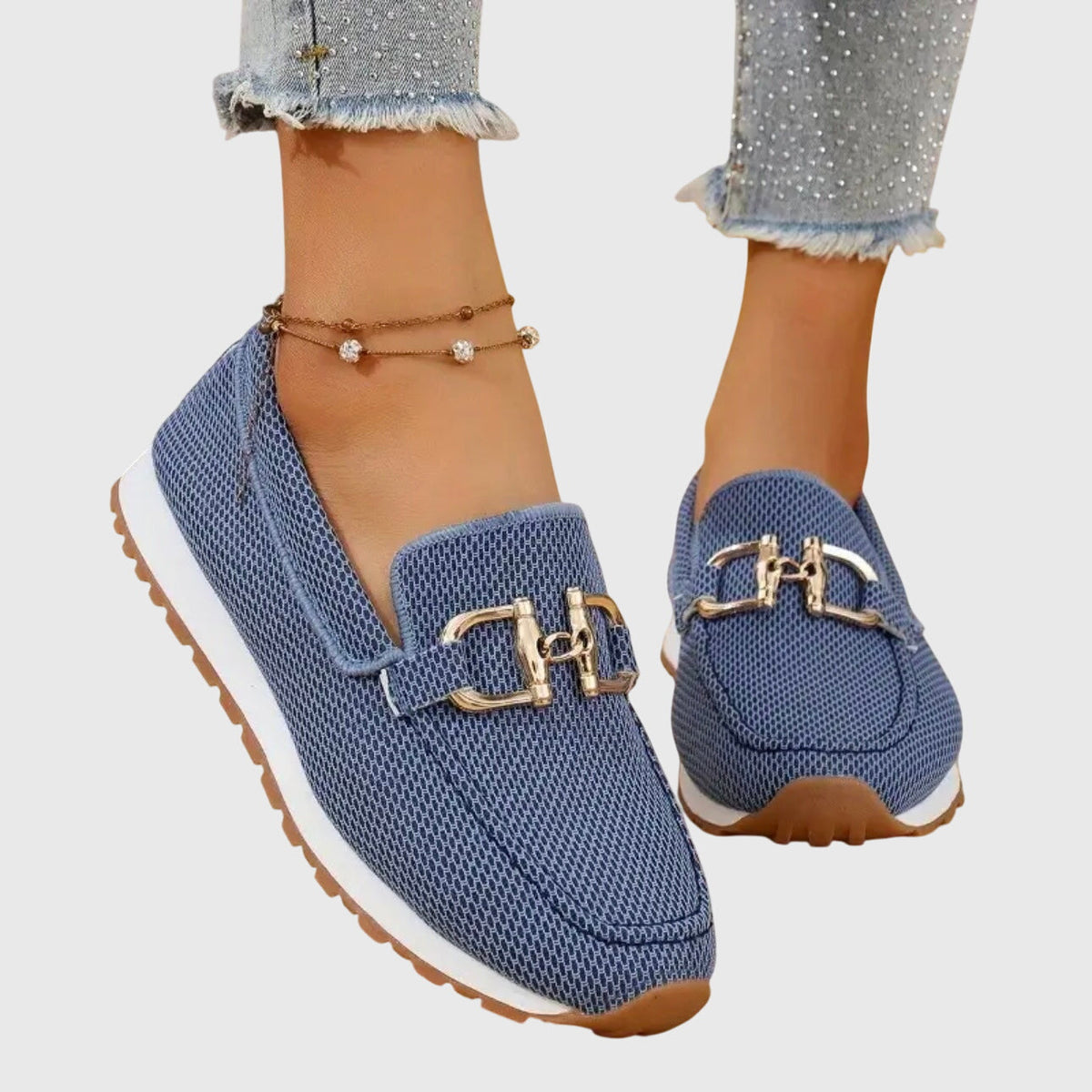 Blue mesh loafers with gold buckle, worn with studded frayed-hem jeans, viewed from the side 1