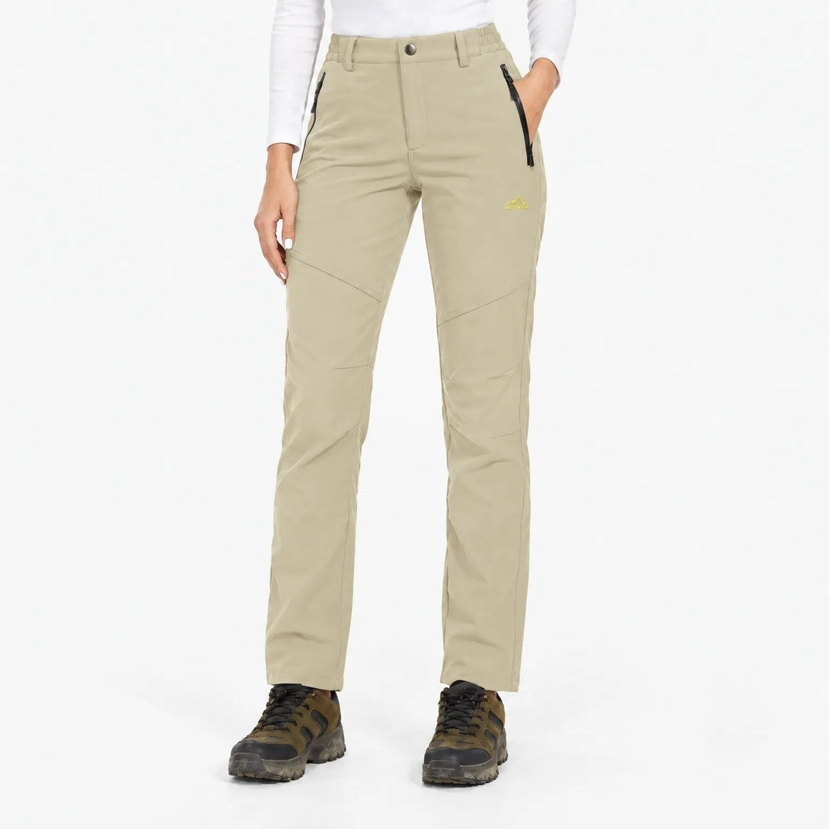 Beige trousers worn by a model, front view with panelled legs and zipped pockets 14