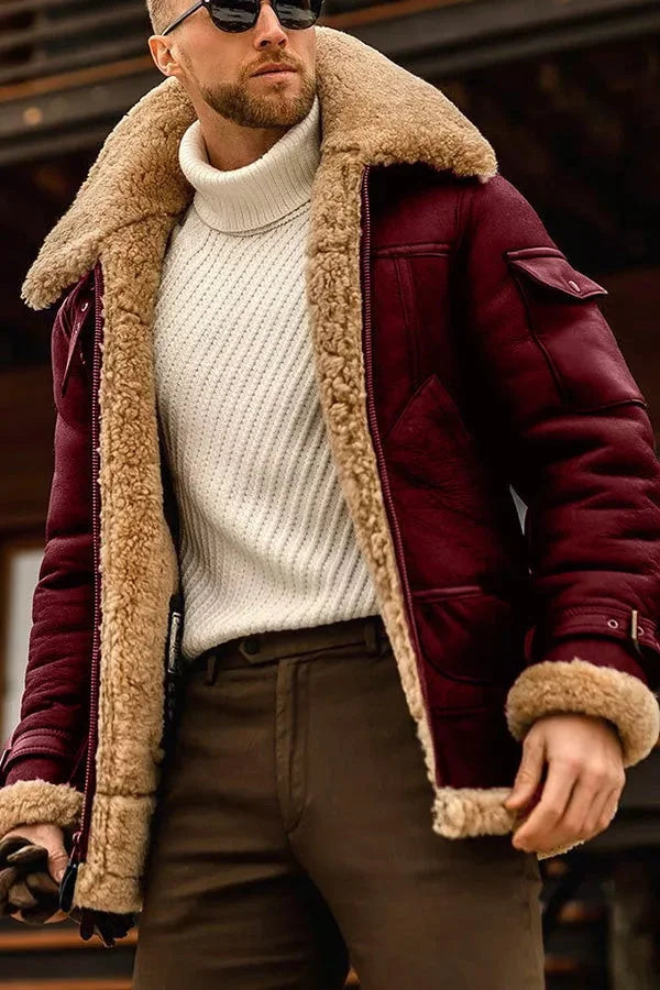 Close-up of the jacket in burgundy with tan shearling collar, cuff and lining, worn over a cream jumper 4