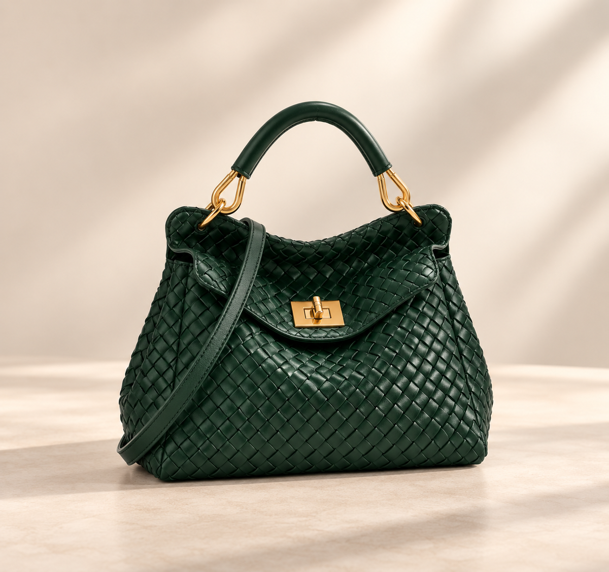 Dark green woven-textured version with gold hardware and crossbody strap, on a pale studio surface 4