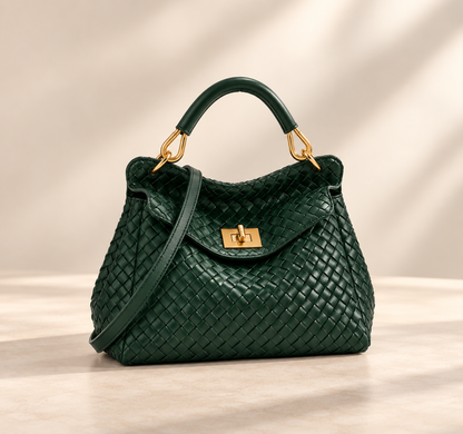 Dark green woven-textured version with gold hardware and crossbody strap, on a pale studio surface 4