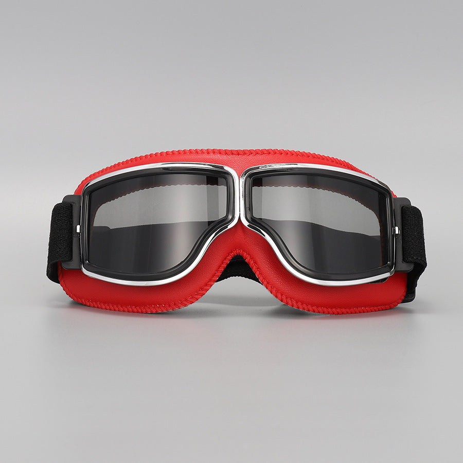 Front view of the red-padded goggles with chrome trim and smoky grey tinted lenses. 11