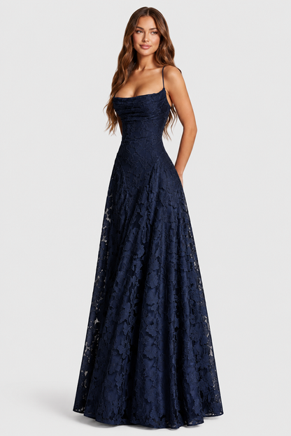 Model in a navy floral lace gown with draped neckline and slim straps, looking off to the side. 12