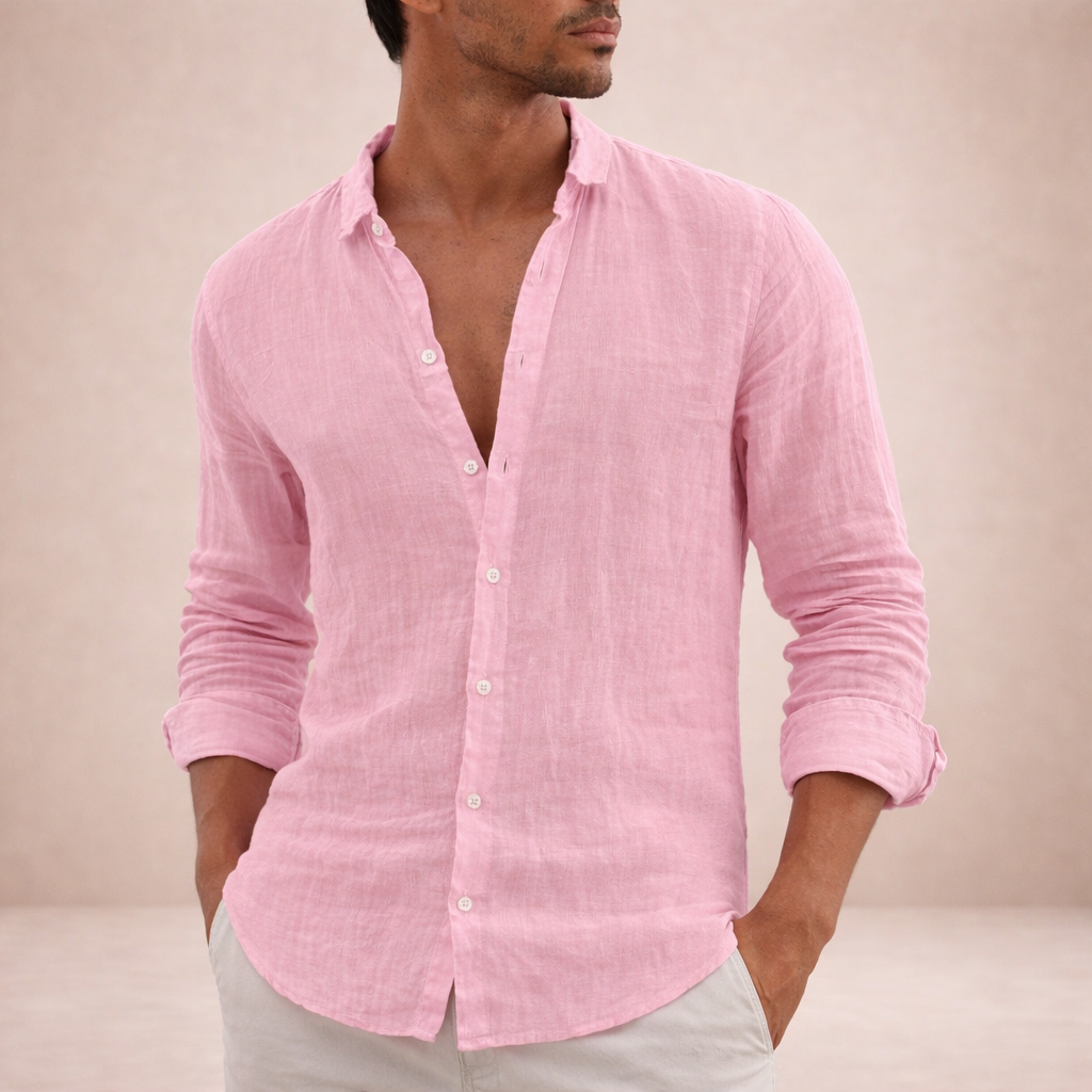 Pink linen shirt on a model with both hands in his trouser pockets, open collar and rolled sleeves. 4